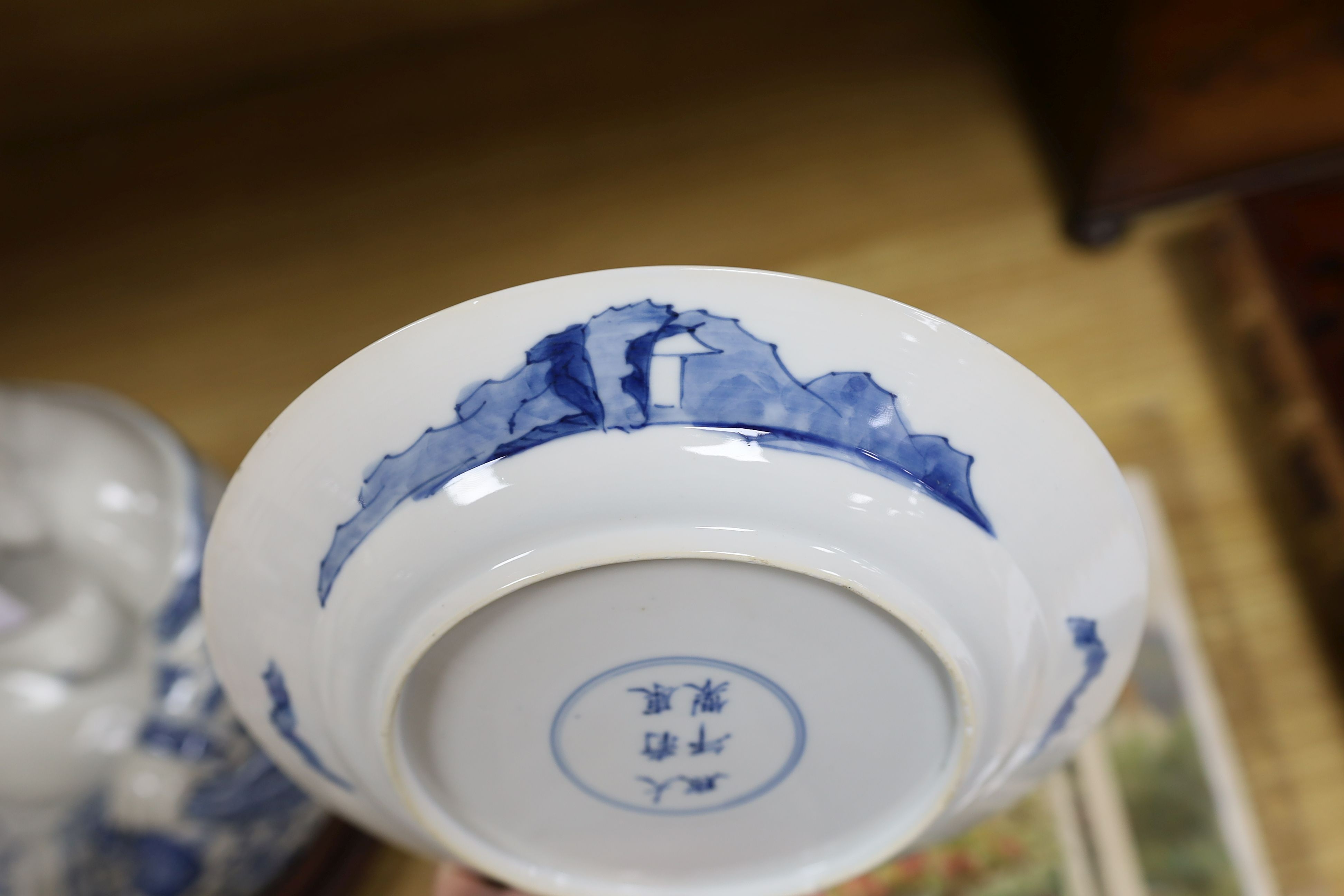 Two Chinese blue and white plates, Kangxi period, one with Kangxi mark the other a Chenghua mark, 21 cms diameter